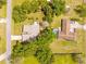 Aerial shot showing a property with mature trees, a pool, and a well-maintained yard at 24076 Ragan Dr, Brooksville, FL 34601