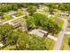 Aerial view of the home in a neighborhood with mature trees, near local roads and other houses at 24076 Ragan Dr, Brooksville, FL 34601