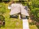 Aerial view of charming home, showcasing its well-maintained lawn and inviting outdoor patio at 24076 Ragan Dr, Brooksville, FL 34601