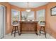 Charming bar area featuring a wine rack, marble floors, and a hanging light fixture at 24076 Ragan Dr, Brooksville, FL 34601