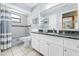 Well-lit bathroom with modern fixtures, granite countertop, tiled shower, and updated vanity at 24076 Ragan Dr, Brooksville, FL 34601