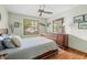Comfortable bedroom with wood floors, wooden furniture, and a window overlooking the neighborhood at 24076 Ragan Dr, Brooksville, FL 34601