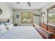 Cozy bedroom with wood floors, wood furniture, and a large window bringing in natural light at 24076 Ragan Dr, Brooksville, FL 34601
