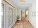 Welcoming entryway featuring beautiful wood floors, decorative lighting, and a leaded-glass front door at 24076 Ragan Dr, Brooksville, FL 34601