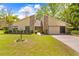 Charming single-story home boasts stone accents, a well-manicured lawn, and a convenient two-car garage at 24076 Ragan Dr, Brooksville, FL 34601