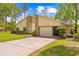 Charming home showcasing a well-maintained lawn and attractive stone and siding exterior at 24076 Ragan Dr, Brooksville, FL 34601
