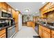 Spacious kitchen with granite counters, a stainless microwave, and oak cabinets at 24076 Ragan Dr, Brooksville, FL 34601