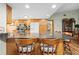 Kitchen with granite countertops, wood cabinets, bar seating, and stainless steel appliances at 24076 Ragan Dr, Brooksville, FL 34601