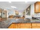 Kitchen with dark granite countertops, oak cabinets, and a breakfast bar at 24076 Ragan Dr, Brooksville, FL 34601