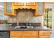 Kitchen with a stainless steel sink, oak cabinets, and diamond backsplash at 24076 Ragan Dr, Brooksville, FL 34601