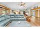 Spacious living room features wood-look floors, a large sectional sofa, and views of the kitchen and dining area at 24076 Ragan Dr, Brooksville, FL 34601