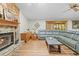 Bright living room features a stone fireplace, wood-look floors, and a comfortable seating area at 24076 Ragan Dr, Brooksville, FL 34601