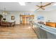 Spacious living room with hardwood floors, ceiling fans, and an open floor plan to dining area and kitchen at 24076 Ragan Dr, Brooksville, FL 34601
