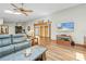 Cozy living room offers wood-look floors, comfortable seating, and a view of the dining area at 24076 Ragan Dr, Brooksville, FL 34601