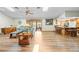 Expansive living room with hardwood floors, modern furniture, and an open floor plan into the kitchen at 24076 Ragan Dr, Brooksville, FL 34601