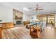 Inviting living room features a stone fireplace, wood-look floors, and a sliding door to the outdoor patio at 24076 Ragan Dr, Brooksville, FL 34601