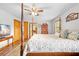 Main bedroom featuring a canopy bed, hardwood floors, and a ceiling fan at 24076 Ragan Dr, Brooksville, FL 34601