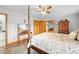 Main bedroom featuring a canopy bed, hardwood floors, and a TV at 24076 Ragan Dr, Brooksville, FL 34601
