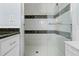 Bathroom showcasing the tile shower with glass door and decorative black tile accents at 24076 Ragan Dr, Brooksville, FL 34601