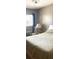 Bedroom with cozy bedding, side table, white chair, and a bright window at 250 Rosery Nw Rd # 337A, Largo, FL 33770