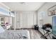 Well-lit bedroom with a cozy bunk bed, wood-look floors, and ample storage space at 2554 Brimhollow Dr, Valrico, FL 33596