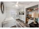Comfortable bedroom featuring wood-look floors, built-in shelving, and ample storage at 2554 Brimhollow Dr, Valrico, FL 33596
