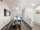 Bright dining room with a modern table and chairs, hardwood floors, and a decorative window accent at 2554 Brimhollow Dr, Valrico, FL 33596