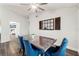 Bright dining room features a modern ceiling fan, wood-look floors, and an adjacent view to the living area at 2554 Brimhollow Dr, Valrico, FL 33596