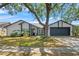 Charming single-story home with well-maintained landscaping and a large shade tree in front yard at 2554 Brimhollow Dr, Valrico, FL 33596