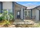 Inviting front porch with seating, decorative plants, and a stylish front door with glass inserts at 2554 Brimhollow Dr, Valrico, FL 33596
