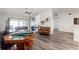 Spacious game room with foosball table, poker table, a ceiling fan, and wood-look floors at 2554 Brimhollow Dr, Valrico, FL 33596