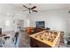 Spacious game room with foosball table, poker table, a ceiling fan, and wood-look floors at 2554 Brimhollow Dr, Valrico, FL 33596