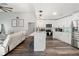 Modern kitchen featuring white cabinets, stainless steel appliances, a kitchen island, and hardwood flooring at 2554 Brimhollow Dr, Valrico, FL 33596