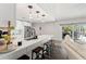 Modern kitchen featuring white cabinetry, stainless appliances, an island with seating, and hardwood floors at 2554 Brimhollow Dr, Valrico, FL 33596