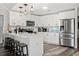 Bright kitchen with white cabinets, stainless steel appliances, and a stylish kitchen island with seating at 2554 Brimhollow Dr, Valrico, FL 33596