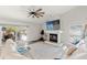 Spacious living room with fireplace, open sliding doors to outside patio, and stylish furnishings at 2554 Brimhollow Dr, Valrico, FL 33596