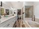 Gorgeous primary bathroom features dual sinks, marble counters, and a glass-enclosed shower at 2554 Brimhollow Dr, Valrico, FL 33596