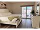 Bright main bedroom features pool access through sliding glass doors and a large dresser for ample storage at 2554 Brimhollow Dr, Valrico, FL 33596