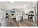 Bright, open floor plan with living room, kitchen, and dining areas with hardwood flooring at 2554 Brimhollow Dr, Valrico, FL 33596