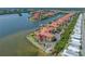 Stunning waterfront condominium complex featuring lush landscaping and serene water views at 2773 Via Cipriani # 1322A, Clearwater, FL 33764