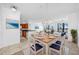 Well-lit dining room with a modern chandelier, an open-concept design, and views of the kitchen and living area at 2773 Via Cipriani # 1322A, Clearwater, FL 33764
