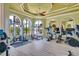 Bright gym featuring modern equipment, large arched windows, and a ceiling fan at 2773 Via Cipriani # 1322A, Clearwater, FL 33764