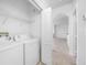 Functional laundry room equipped with modern washer and dryer units and shelving at 2773 Via Cipriani # 1322A, Clearwater, FL 33764
