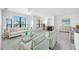 Bright living room with a coastal aesthetic, featuring large windows, white furniture, and a fireplace at 2773 Via Cipriani # 1322A, Clearwater, FL 33764
