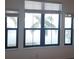 A water view from a room with palm trees and foliage visible through the window, showcasing a tranquil view at 2773 Via Cipriani # 1322A, Clearwater, FL 33764