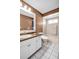 Bathroom with tile flooring, vanity sink, and shower-tub combo with neutral tiling at 2814 Lomond Dr, Palm Harbor, FL 34684