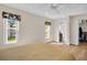 Bedroom features a walk-in closet, en suite bathroom, ceiling fan, and two windows at 2814 Lomond Dr, Palm Harbor, FL 34684
