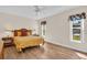 Bedroom with two large windows, hardwood floors, and a ceiling fan at 2814 Lomond Dr, Palm Harbor, FL 34684