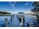 A boat parked on a community boat dock with views of the lake and treeline at 2814 Lomond Dr, Palm Harbor, FL 34684