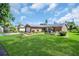 Expansive front lawn and landscaping highlight this charming single-story home at 2814 Lomond Dr, Palm Harbor, FL 34684